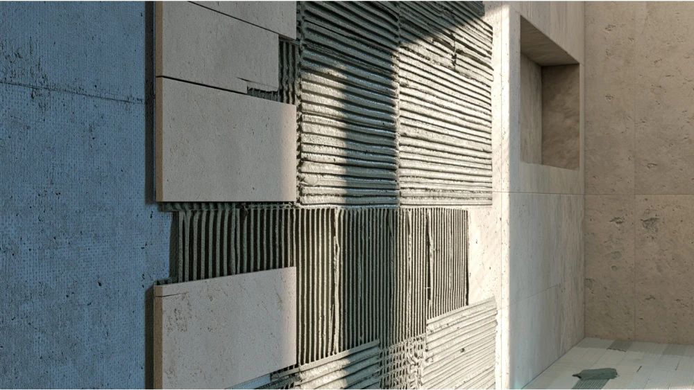 Shower tile installation showing thinset mortar over a waterproof membrane beneath the tile